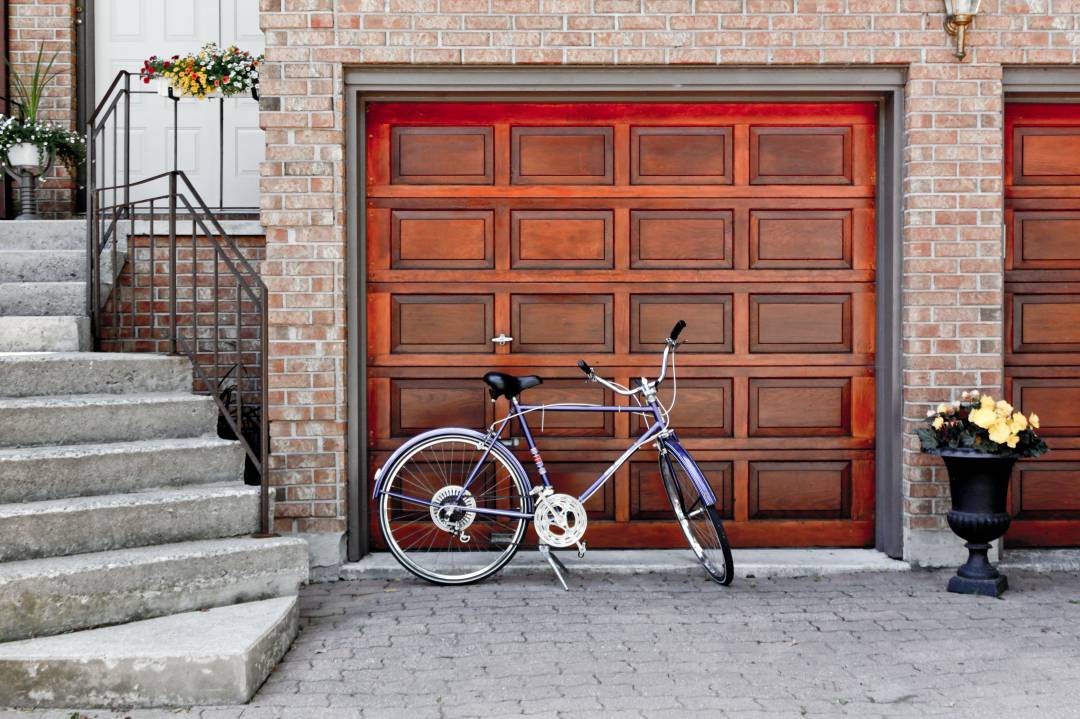 Purple Bike Parked Outside A Garage Door